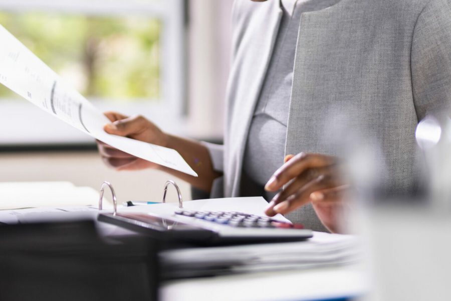 African American Accountant Or Auditor With Calculator