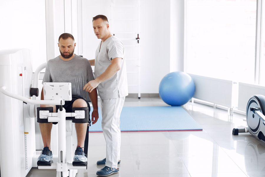 Patient has a rehabilitation in physiotherapy clinic. Doctor in a uniform.